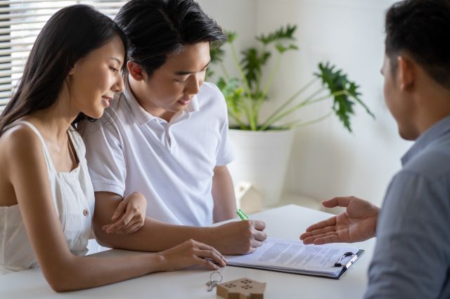young man and woman at desk with professional